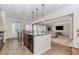 Open kitchen featuring a central island, granite countertops, and pendant lighting at 3391 Meadow Grass Dr, Dacula, GA 30019