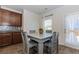 Eat-in kitchen showcases wood cabinets, stone tile backsplash and gray table at 3391 Meadow Grass Dr, Dacula, GA 30019
