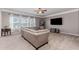 Bright living room with a ceiling fan, a large sofa, and plenty of natural light at 3391 Meadow Grass Dr, Dacula, GA 30019