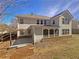 Exterior view of a home featuring a screened in back porch and large backyard at 4913 Sydney Ln, Marietta, GA 30066