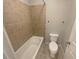 Bathroom features a tiled shower-tub combination and a white toilet, with a neutral color palette at 4913 Sydney Ln, Marietta, GA 30066