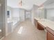 Bright and airy bathroom with dual vanities, soaking tub, and tiled floors at 4913 Sydney Ln, Marietta, GA 30066