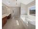 Primary bathroom featuring a tub, double vanity sinks, and large window at 4913 Sydney Ln, Marietta, GA 30066