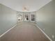 Empty bedroom featuring carpet, a ceiling fan, and three windows with blinds at 4913 Sydney Ln, Marietta, GA 30066