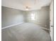 Spacious carpeted bedroom features neutral walls and natural light from a single window at 4913 Sydney Ln, Marietta, GA 30066