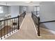 Upstairs hallway with rod iron railings and views of the living room fireplace below at 4913 Sydney Ln, Marietta, GA 30066