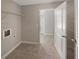 Tiled laundry room with open shelving and washer-dryer hookups ready for appliances at 4913 Sydney Ln, Marietta, GA 30066