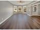 Bright living room featuring a ceiling fan, hardwood floors, and large windows at 4913 Sydney Ln, Marietta, GA 30066