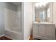 Bathroom showcasing a tub and shower combo, modern vanity, and a spacious mirror at 1579 Eastern Sunrise Ln, Decatur, GA 30034