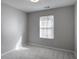 Neutral bedroom featuring plush carpet and a window for natural light at 1579 Eastern Sunrise Ln, Decatur, GA 30034