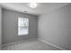 Cozy bedroom with a neutral color scheme, plush carpeting, and a window providing natural light at 1579 Eastern Sunrise Ln, Decatur, GA 30034