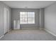Spacious bedroom with a neutral color scheme, plush carpeting, and a window providing natural light at 1579 Eastern Sunrise Ln, Decatur, GA 30034