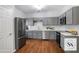 Stylish kitchen featuring gray cabinetry, stainless steel appliances, and a classic subway tile backsplash at 1579 Eastern Sunrise Ln, Decatur, GA 30034