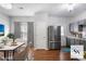 Modern kitchen and dining area featuring stainless steel appliances, gray cabinets, and hardwood floors at 1579 Eastern Sunrise Ln, Decatur, GA 30034