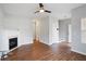 Spacious open-concept living room with a cozy fireplace, modern lighting, and beautiful hardwood flooring at 1579 Eastern Sunrise Ln, Decatur, GA 30034