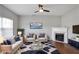 Bright living room with fireplace, plush seating, a stylish rug, and ample natural light from a large window at 1579 Eastern Sunrise Ln, Decatur, GA 30034
