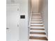 Clean staircase featuring white risers, wooden treads, and a painted white handrail at 1579 Eastern Sunrise Ln, Decatur, GA 30034