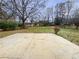 View of a large backyard with a concrete patio and mature trees at 7648 Mount Zion Blvd, Jonesboro, GA 30236