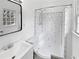 Bathroom with white subway tile shower, a white toilet, and a black framed mirror at 7648 Mount Zion Blvd, Jonesboro, GA 30236