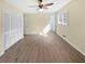 Bright bedroom featuring a ceiling fan, neutral paint, and wood-look floors at 7648 Mount Zion Blvd, Jonesboro, GA 30236