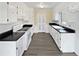 Kitchen with white cabinets, dark counter tops and stainless steel appliances at 7648 Mount Zion Blvd, Jonesboro, GA 30236