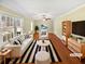 Bright, staged living room with hardwood floors, large windows and a ceiling fan at 7648 Mount Zion Blvd, Jonesboro, GA 30236