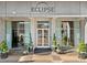 Welcoming entrance to Eclipse Buckhead building with manicured greenery, clean doors, and concrete facade at 250 Pharr Ne Rd # 1812, Atlanta, GA 30305