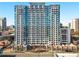 High-rise condominium building with multiple balconies and glass windows on a sunny day at 250 Pharr Ne Rd # 1812, Atlanta, GA 30305