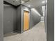 Long condo hallway with gray textured wallpaper and light neutral carpet leads to unit door at 250 Pharr Ne Rd # 1812, Atlanta, GA 30305