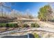 A beautiful backyard features a rock drainage system, a plush lawn, and mature landscaping at 7145 Hartsfield Pl, Suwanee, GA 30024