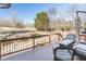 Scenic backyard view from the deck, featuring a large field with trees and a wooden fence at 7145 Hartsfield Pl, Suwanee, GA 30024