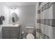 Bathroom features include updated vanity, soft gray walls, and decorative shower curtain at 7145 Hartsfield Pl, Suwanee, GA 30024