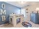 Stylish bedroom featuring a loft bed, blue accents, and playful sports themed decor at 7145 Hartsfield Pl, Suwanee, GA 30024