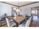 Elegant dining area featuring modern light fixture and stylish furniture at 7145 Hartsfield Pl, Suwanee, GA 30024