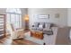 Comfortable living room featuring neutral decor, plush seating, and wood floors at 7145 Hartsfield Pl, Suwanee, GA 30024