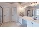 Bright main bathroom featuring double sinks, a large mirror, and access to a walk-in shower at 7145 Hartsfield Pl, Suwanee, GA 30024