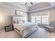 Cozy main bedroom with tray ceiling, carpet, and plenty of natural light from the windows at 7145 Hartsfield Pl, Suwanee, GA 30024