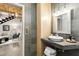 Modern bathroom featuring stone tiles, a vessel sink, and stylish lighting fixtures seen from the living room at 834 Dekalb Ne Ave # D, Atlanta, GA 30307