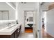 Modern bathroom featuring dual sinks, vanity, and an open doorway to the bedroom at 834 Dekalb Ne Ave # D, Atlanta, GA 30307