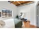 Bright bedroom with exposed ceiling, hardwood floors, large window, and home gym equipment at 834 Dekalb Ne Ave # D, Atlanta, GA 30307