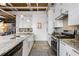 Contemporary kitchen with white cabinetry, granite countertops, stainless steel appliances, and an open layout at 834 Dekalb Ne Ave # D, Atlanta, GA 30307