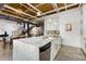 Bright open kitchen featuring white cabinetry, granite countertops, stainless steel appliances, and a view of dining area at 834 Dekalb Ne Ave # D, Atlanta, GA 30307