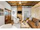 Living room featuring hardwood floors, modern furniture, and a television with wooden doors at 834 Dekalb Ne Ave # D, Atlanta, GA 30307