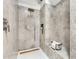 Walk-in shower featuring gray stone tile, rainfall shower head, and bench at 834 Dekalb Ne Ave # D, Atlanta, GA 30307