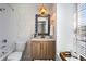 Bathroom with patterned wallpaper, wood vanity and a shower/tub combo at 9 Market Square Nw Pl, Atlanta, GA 30318