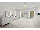 Bright, well-lit bedroom with a large bed, dresser, and multiple windows at 9 Market Square Nw Pl, Atlanta, GA 30318