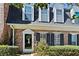 Charming brick home featuring a decorative front door with a wreath and black shutters at 9 Market Square Nw Pl, Atlanta, GA 30318