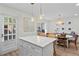 Bright and functional kitchen with updated appliances, a center island, and a view to the dining area at 9 Market Square Nw Pl, Atlanta, GA 30318