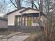 Charming bungalow featuring a welcoming porch, a newly painted facade, and a vibrant green door at 1170 Booker Sw Ave, Atlanta, GA 30310