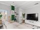 Bright living area featuring a comfortable sofa, a media center, and large windows at 2161 Peachtree Ne Rd # 508, Atlanta, GA 30309